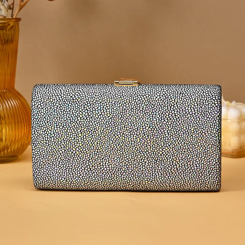 Black and white patterned clutch bag on a beige background