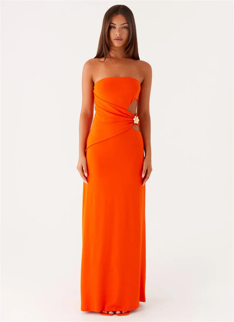 Woman wearing an orange strapless gown on a white background