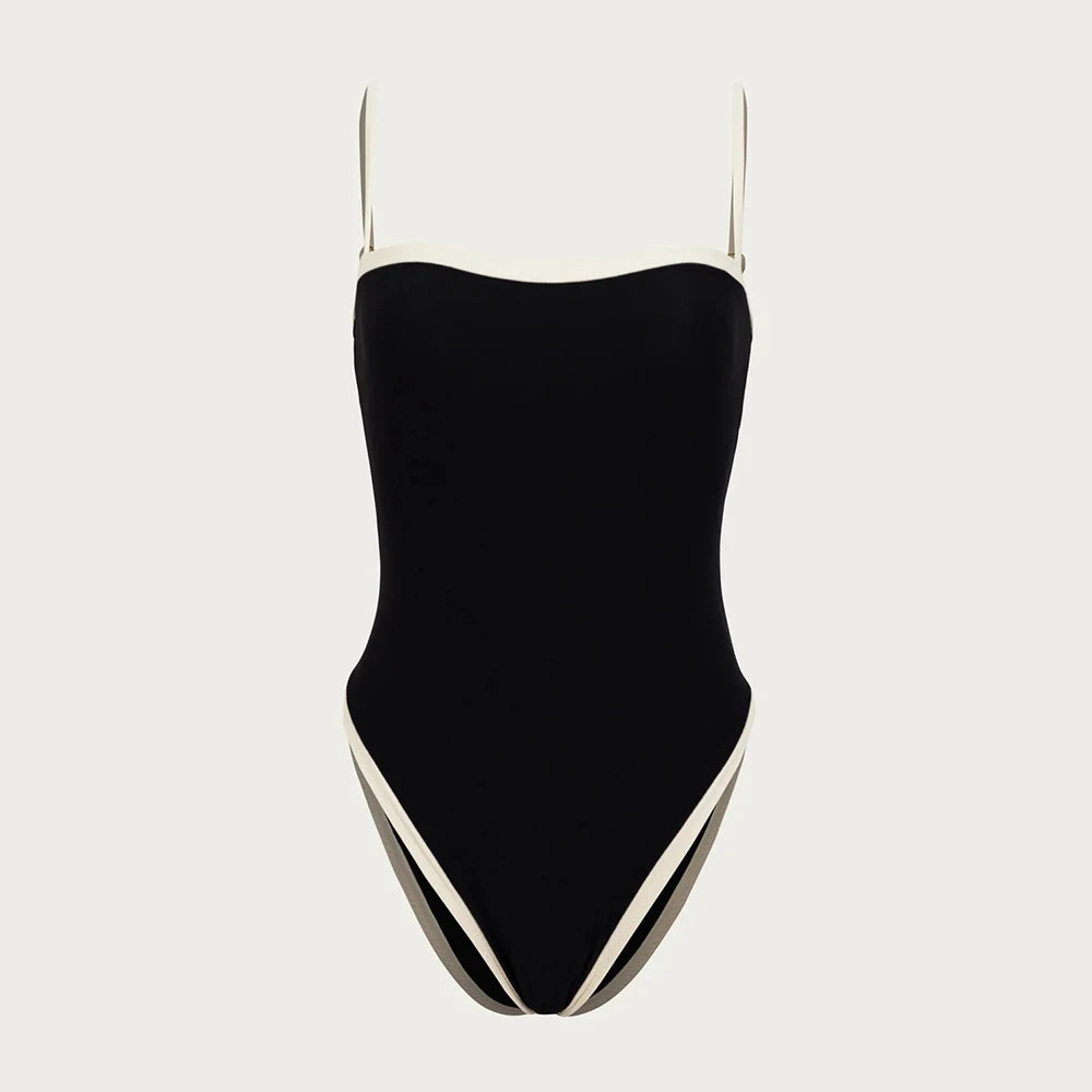 Black swimsuit with thin straps on a light gray background