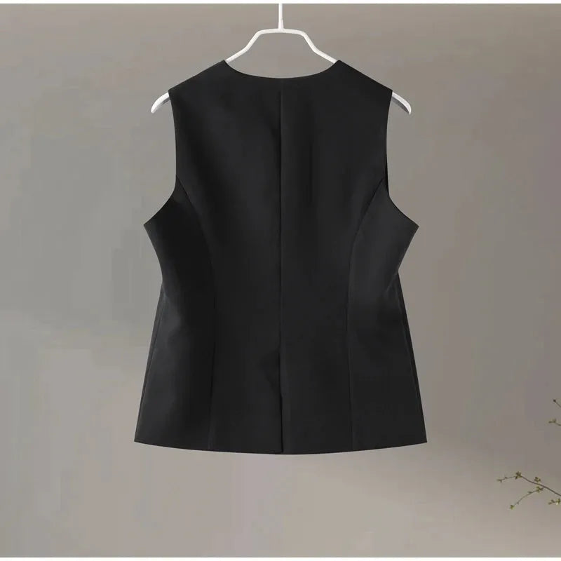 Black sleeveless dress on a hanger against a plain background.