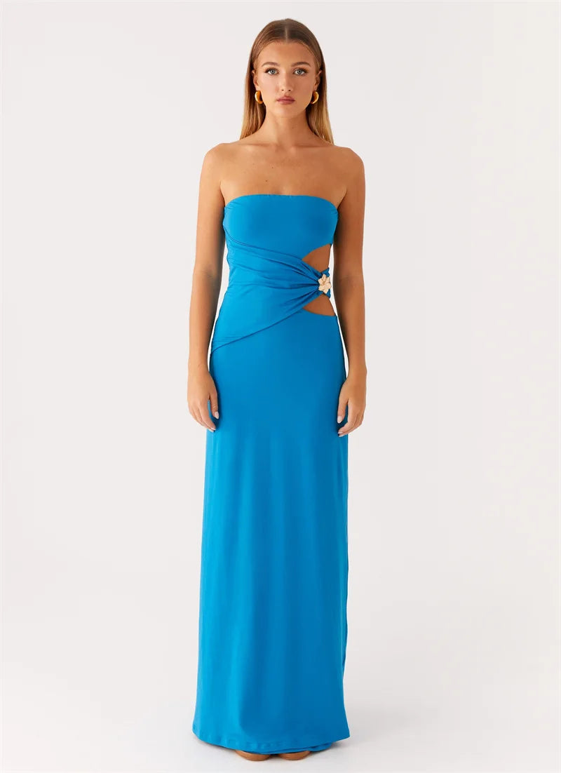 Woman wearing a blue strapless gown with cut-out design on a white background