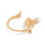 Gold ring with a lion head and pearl on a white background