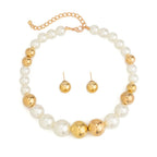 Pearl and gold necklace with matching earrings on a white background