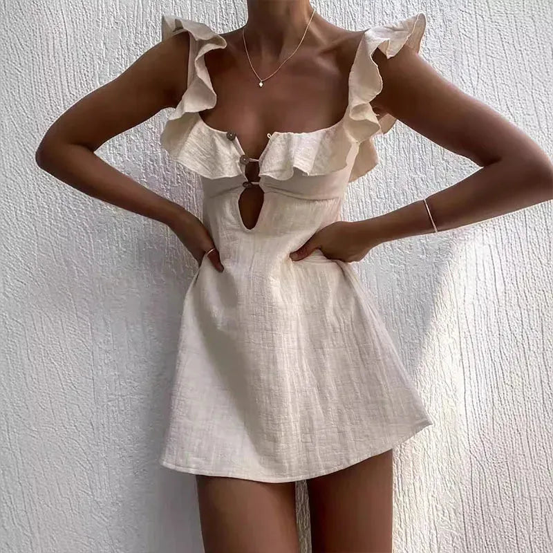 White dress with ruffled straps worn by a model against a plain background.
