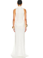 Woman wearing a white sleeveless dress with gold accents on a white background
