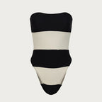 Black and beige strapless swimsuit on a light gray background