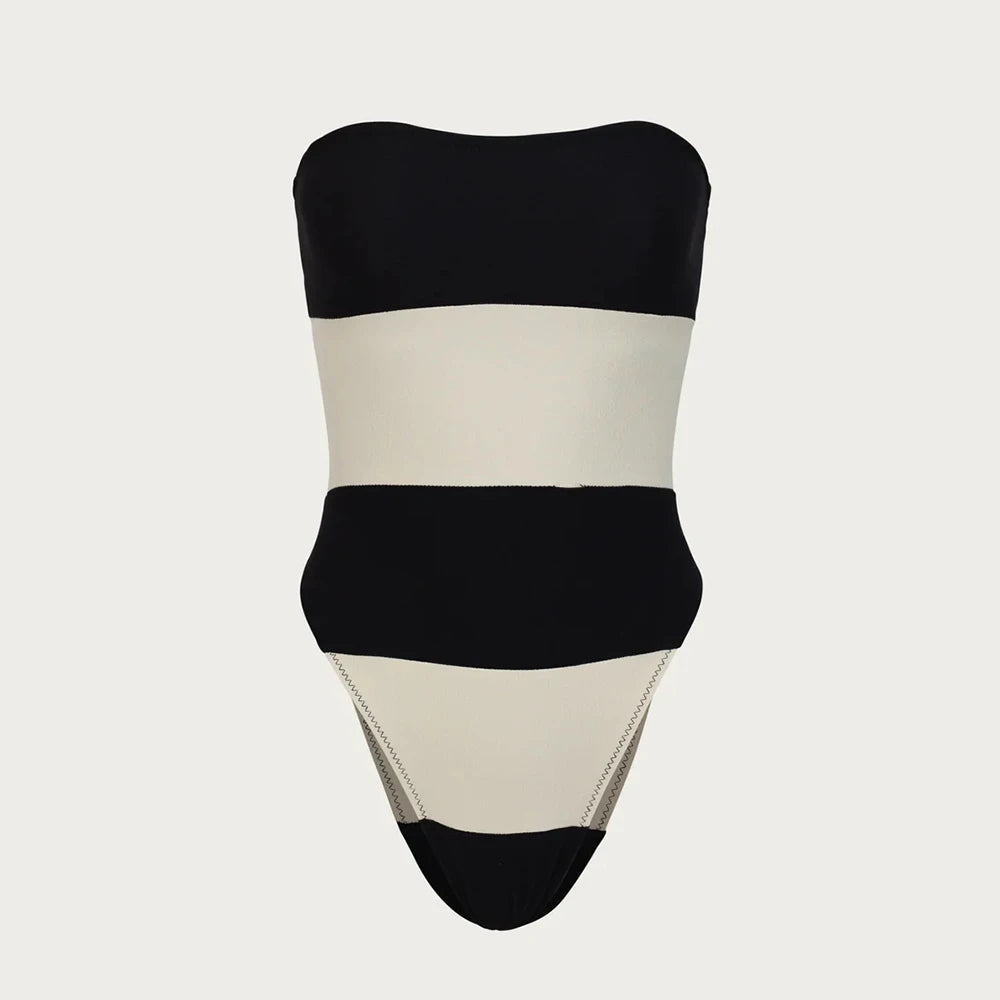 Black and beige strapless swimsuit on a light gray background