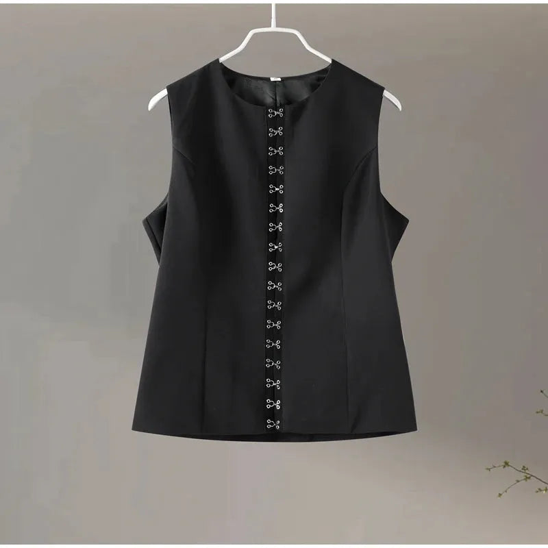 Black sleeveless top with decorative front panel on a hanger against a plain background.