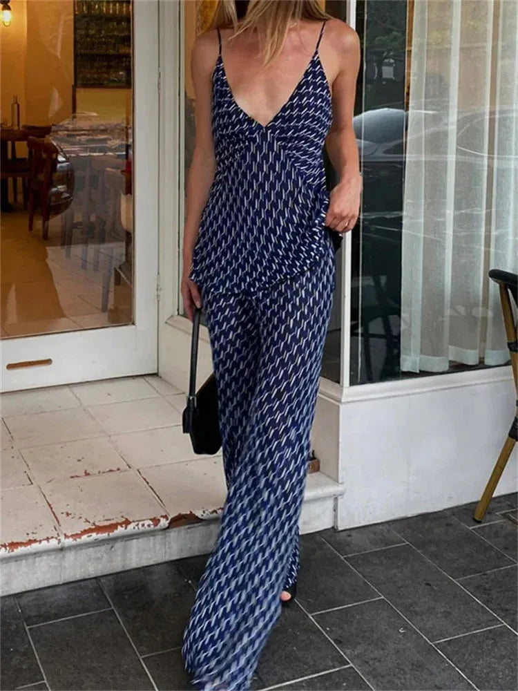 Person wearing a blue patterned outfit standing on a tiled floor.