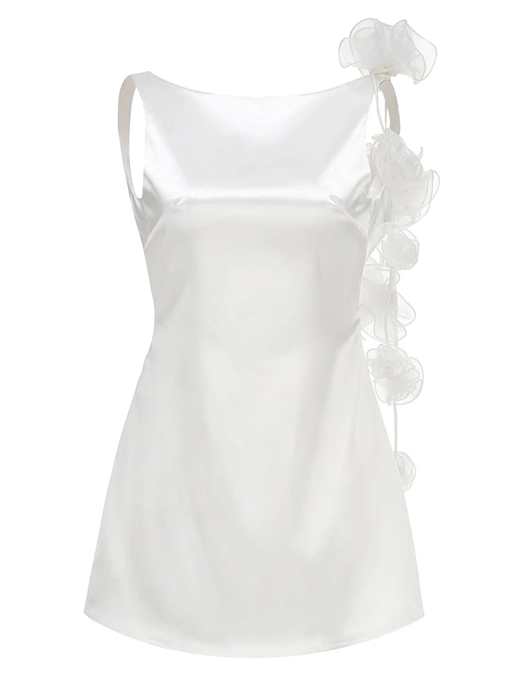 White satin camisole with ruffled details on a white background