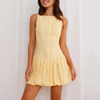 Woman wearing a yellow dress against a white background