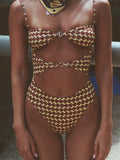 Person wearing a patterned swimsuit with cut-out design.