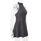 Black polka dot dress on a mannequin against a white background