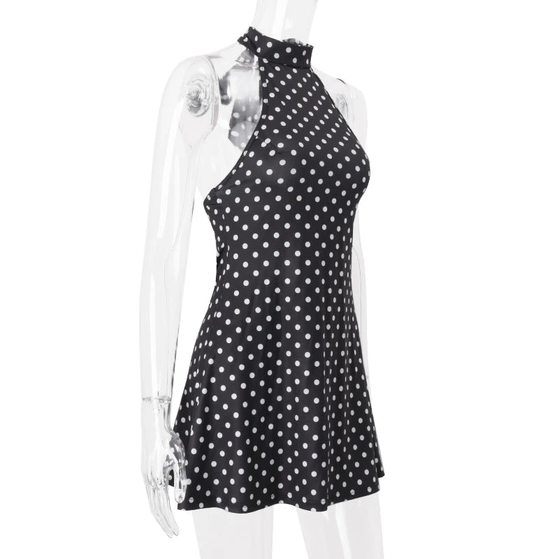 Black polka dot dress on a mannequin against a white background