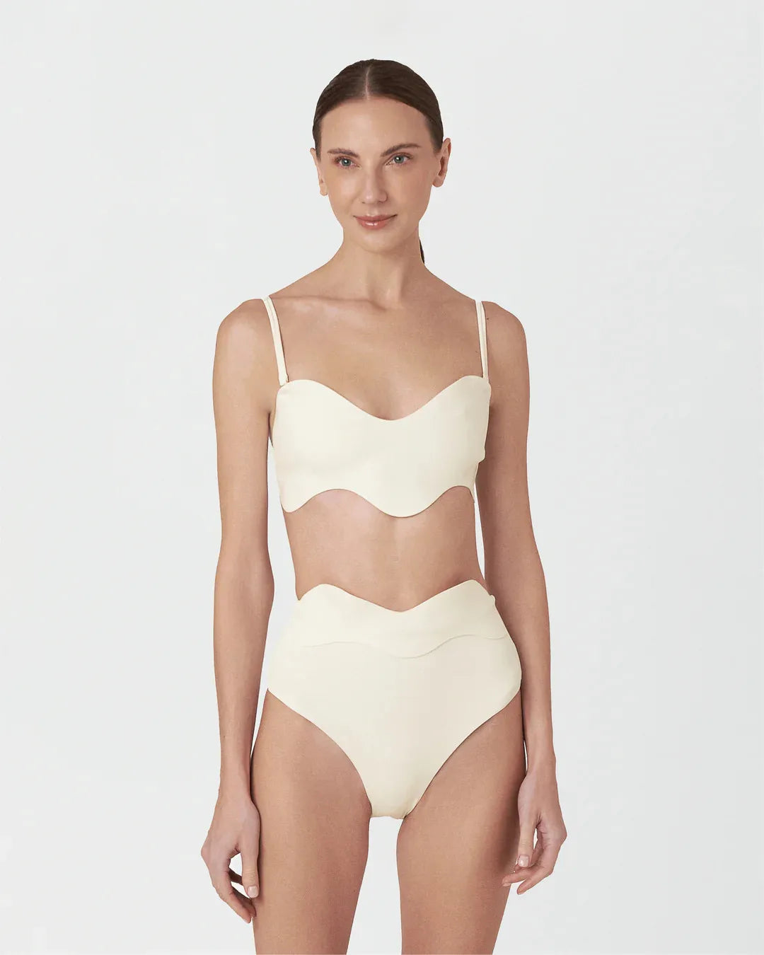 Woman wearing a beige swimsuit on a white background