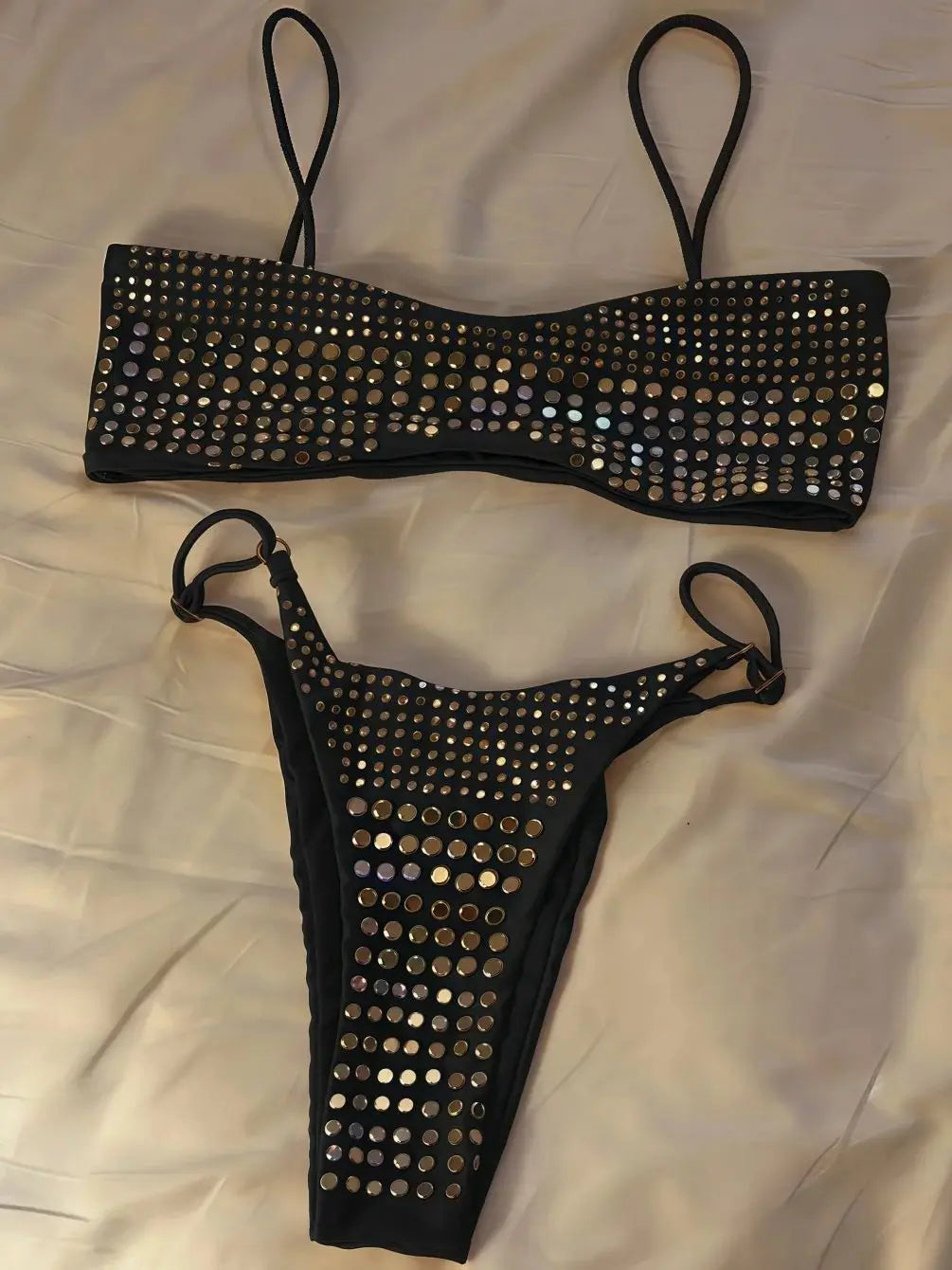 Black bikini set with studs on a white background