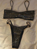 Black bikini set with studs on a white background