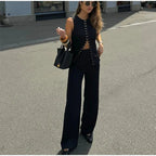 Woman in black outfit walking on street