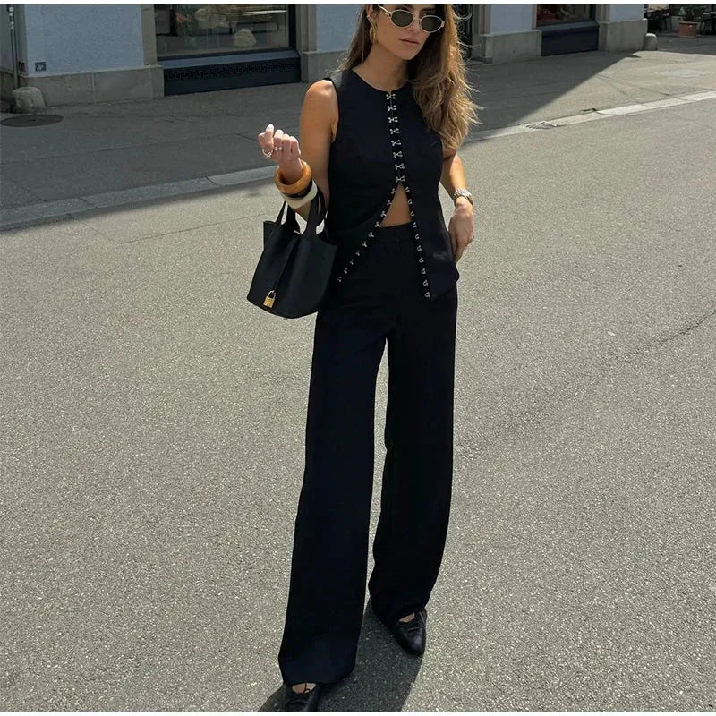 Woman in black outfit walking on street