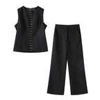 Black sleeveless top and pants set on a white background