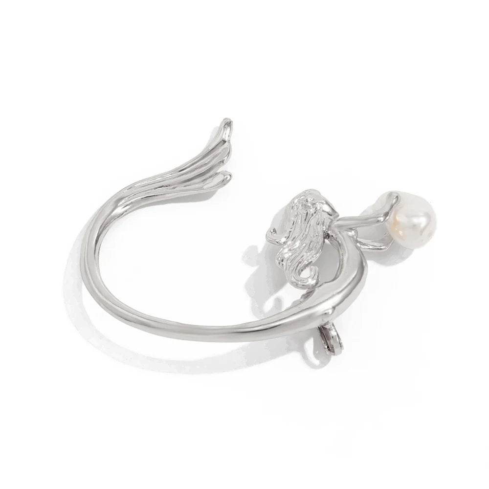 Silver earring with a pearl on a white background