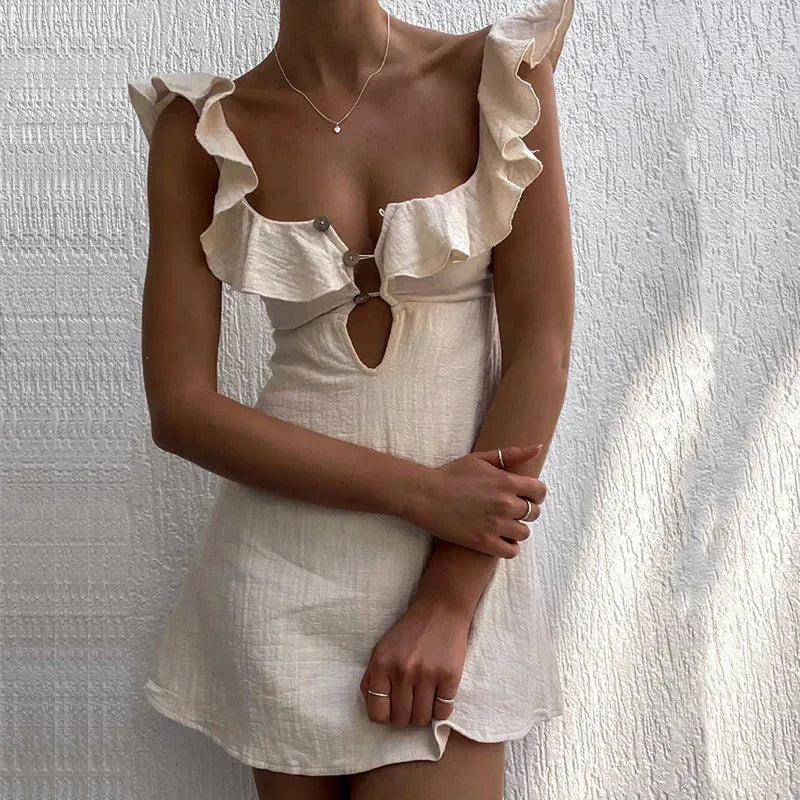 White dress with ruffled details on a textured white background