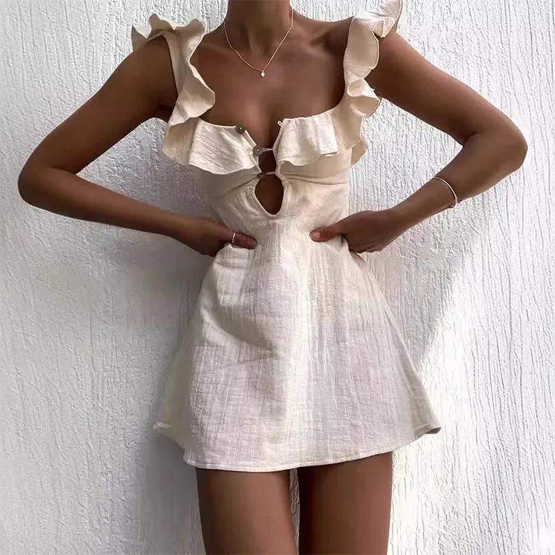 A beige mini dress with hollow out and ruffles, displayed on a model against a white background.