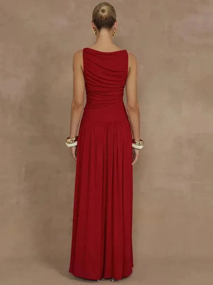 Person wearing a long red dress against a brown background