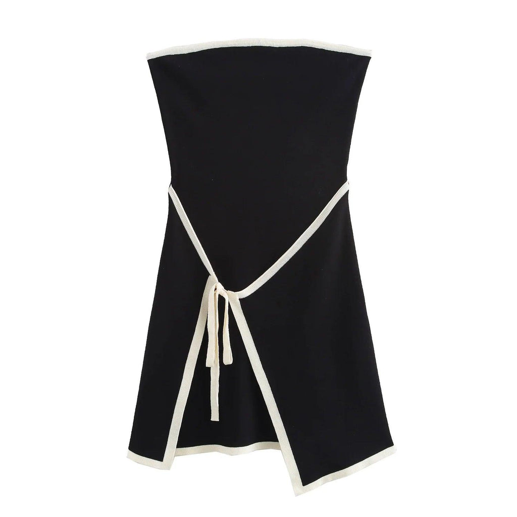 A black strapless mini dress with a solid backless design above knee, featuring a black belt.