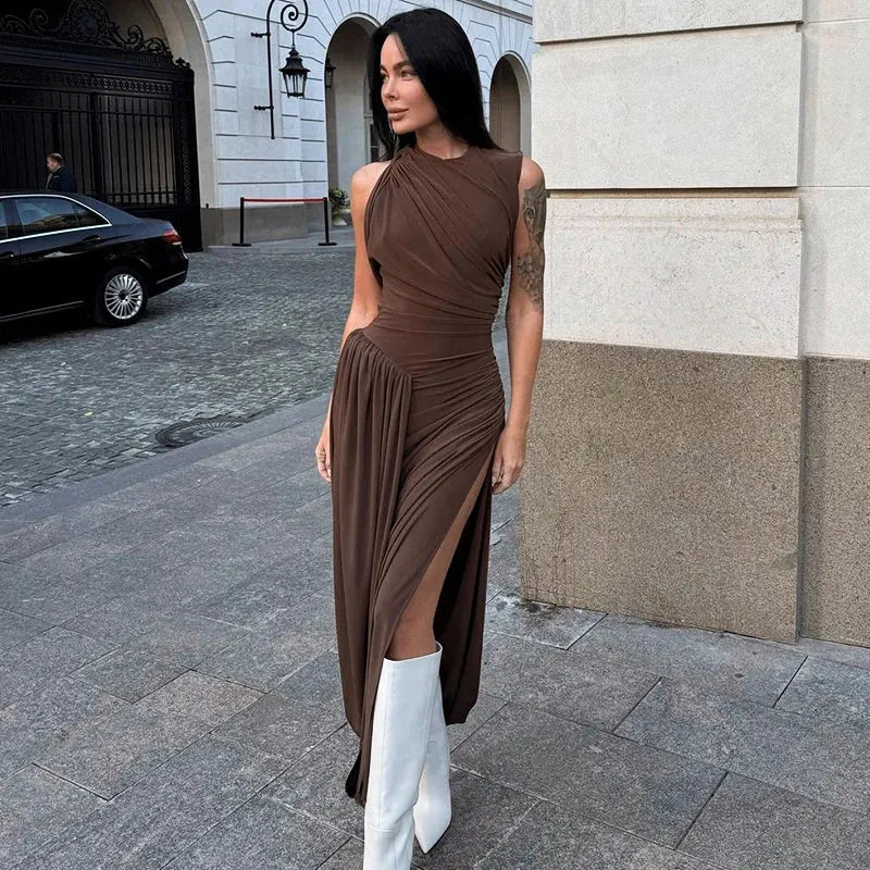 A person wearing a brown midi dress with a ruched waist and asymmetrical neckline, paired with white boots.