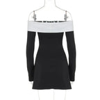 Black and white dress on a hanger against a white background