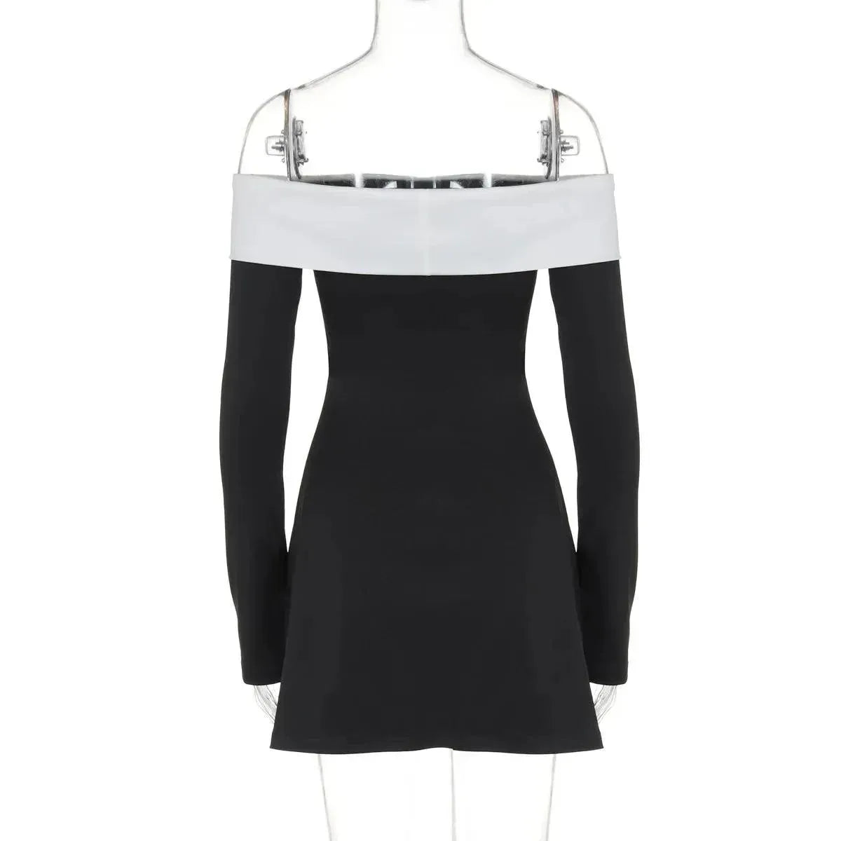 Black and white dress on a hanger against a white background
