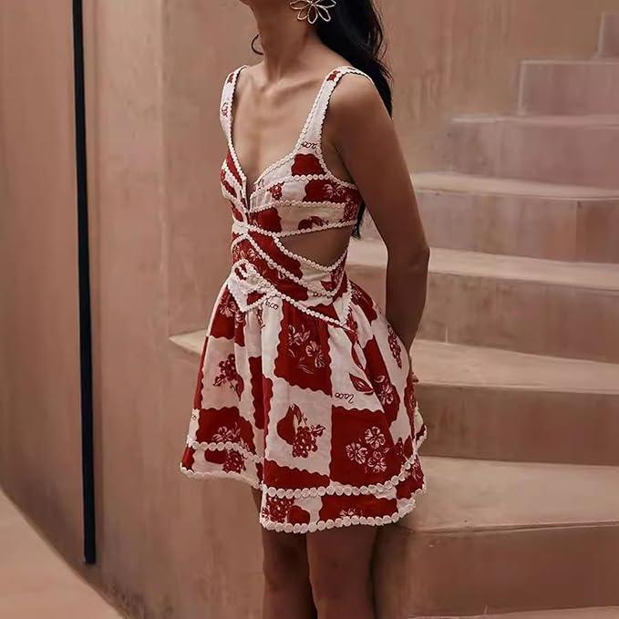 A woman wearing a red and white floral mini dress with a V-neck and sleeveless design, standing on a staircase.