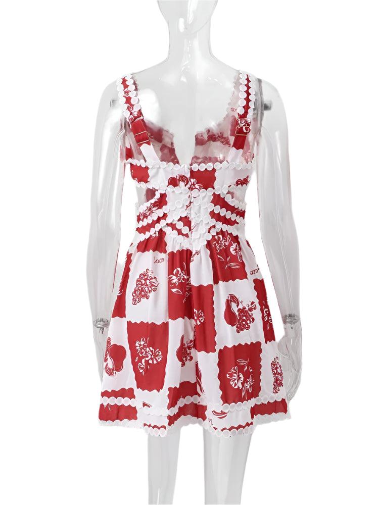 A woman wearing a red and white floral mini dress with a V-neck and sleeveless design, standing on a staircase.