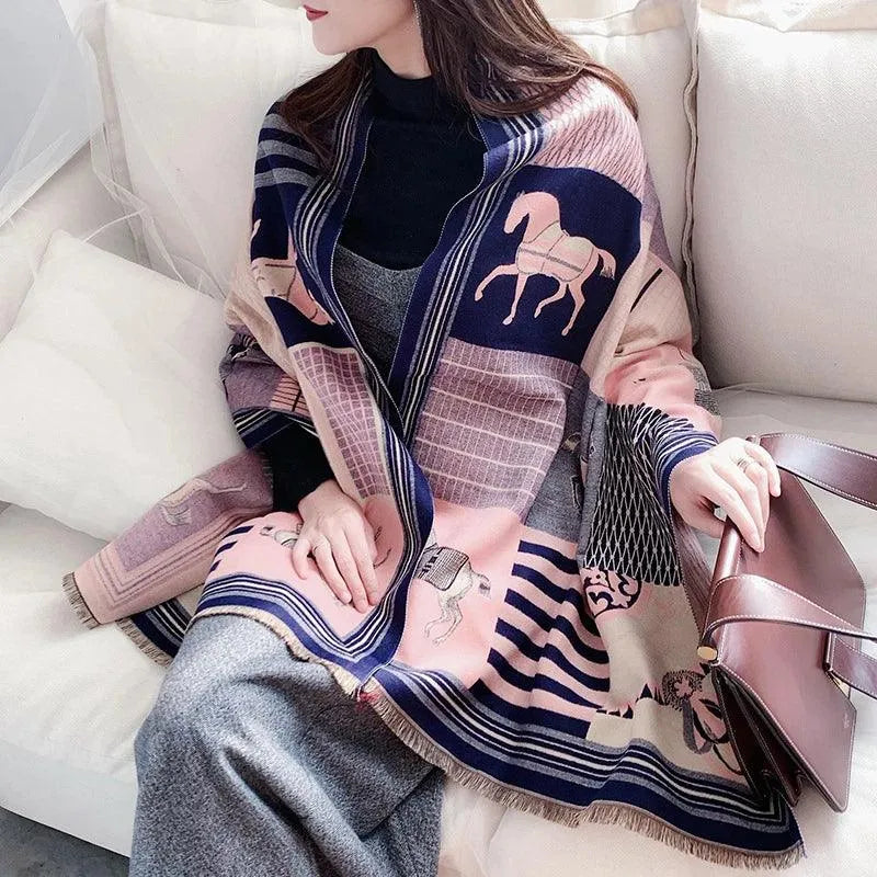 A person sitting on a couch wearing a multicolored geometric patterned scarf and a black jacket, holding a brown purse.