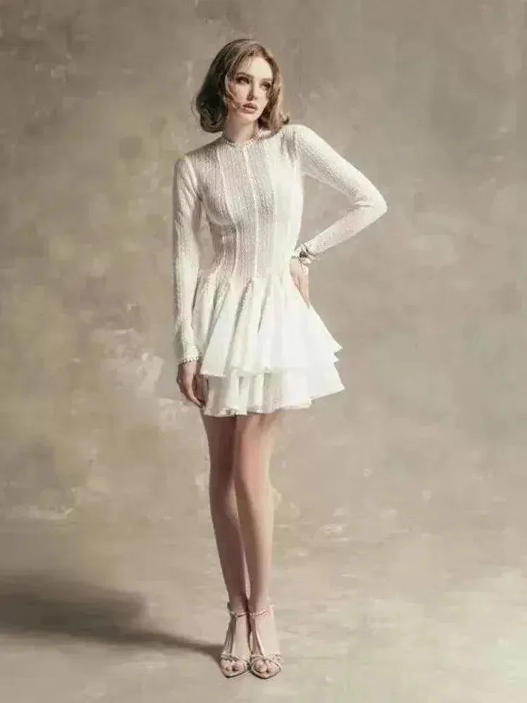 Woman in a white dress against a textured background