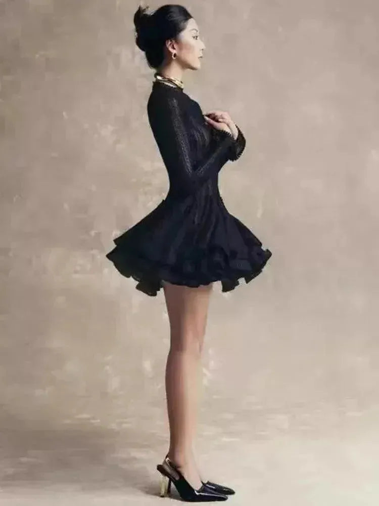 Woman in a black dress against a neutral background