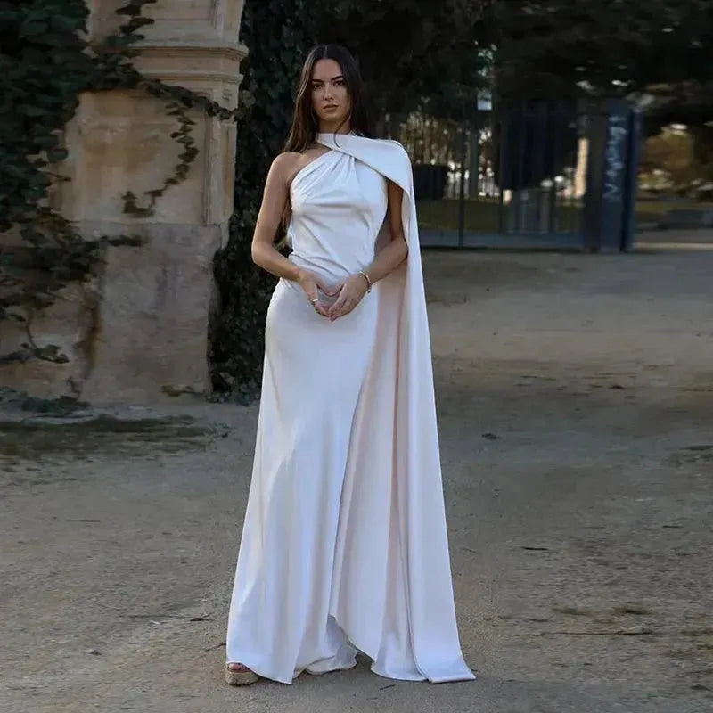 Woman in a white dress standing in an outdoor setting