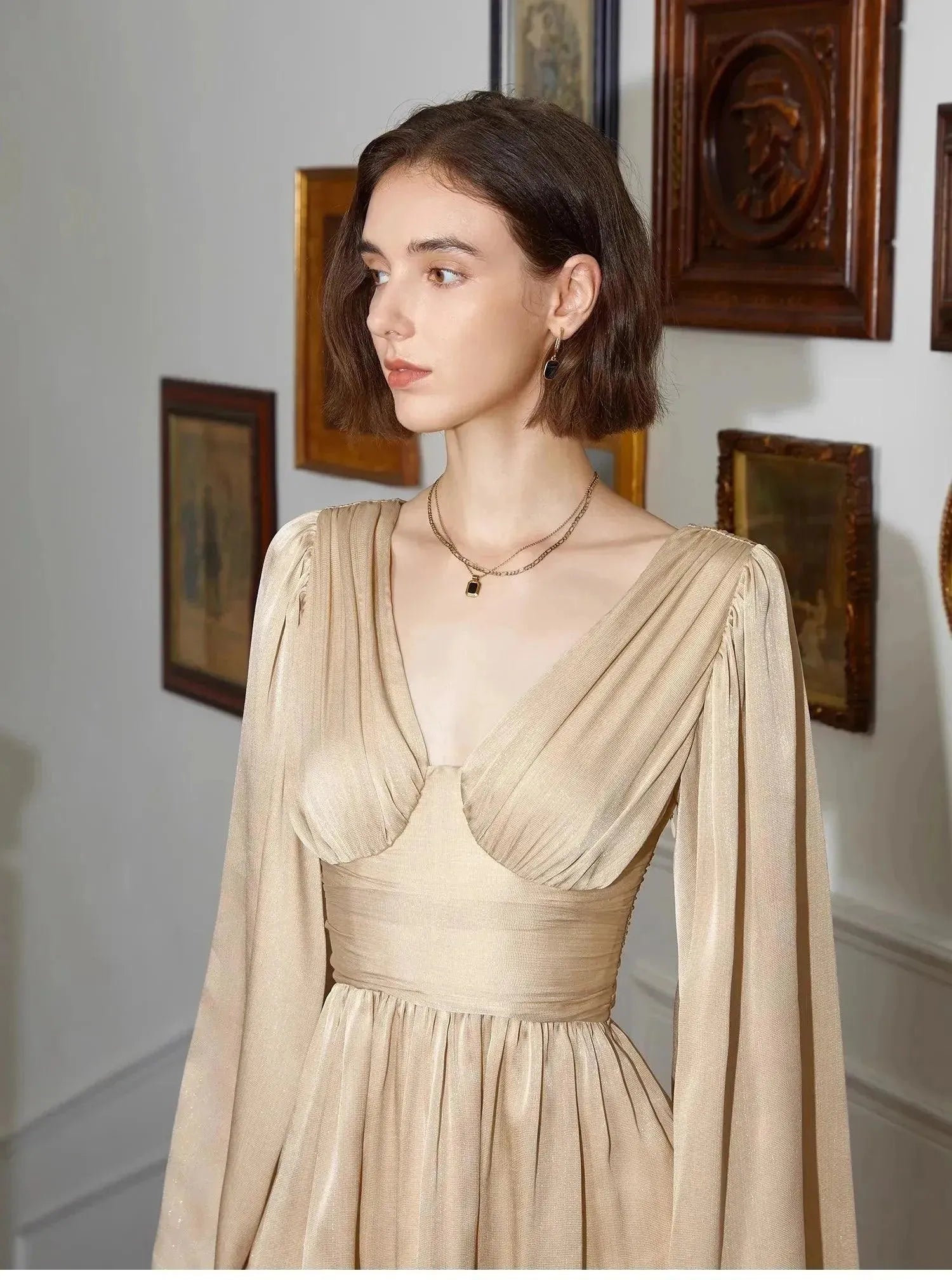 Woman in a beige vintage dress in an artful setting