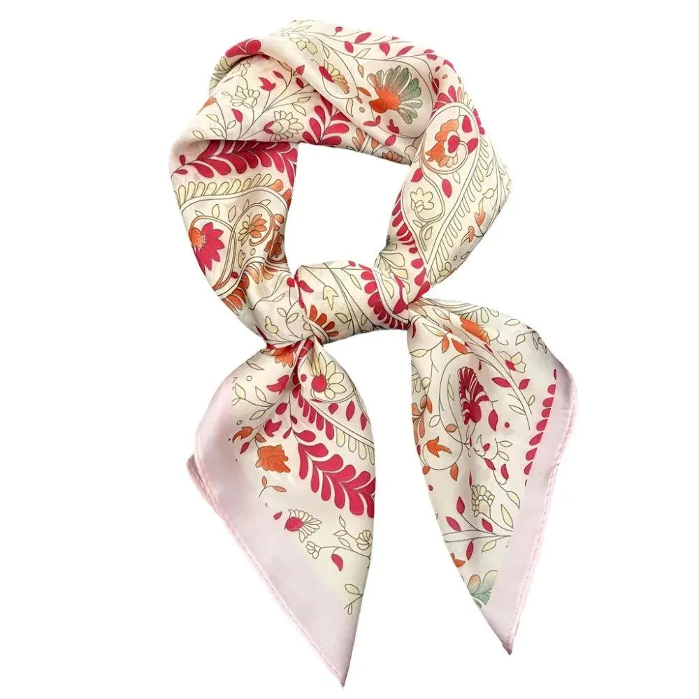 A multicolored floral print silk scarf wrapped around a head, with prominent pink and orange flowers.