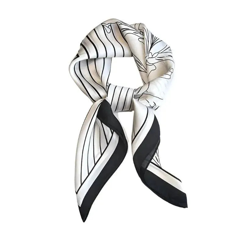 A white and black striped silk scarf tied in a knot, displayed against a white background.