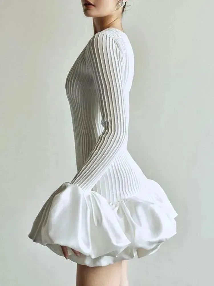 White pleated dress on a plain background