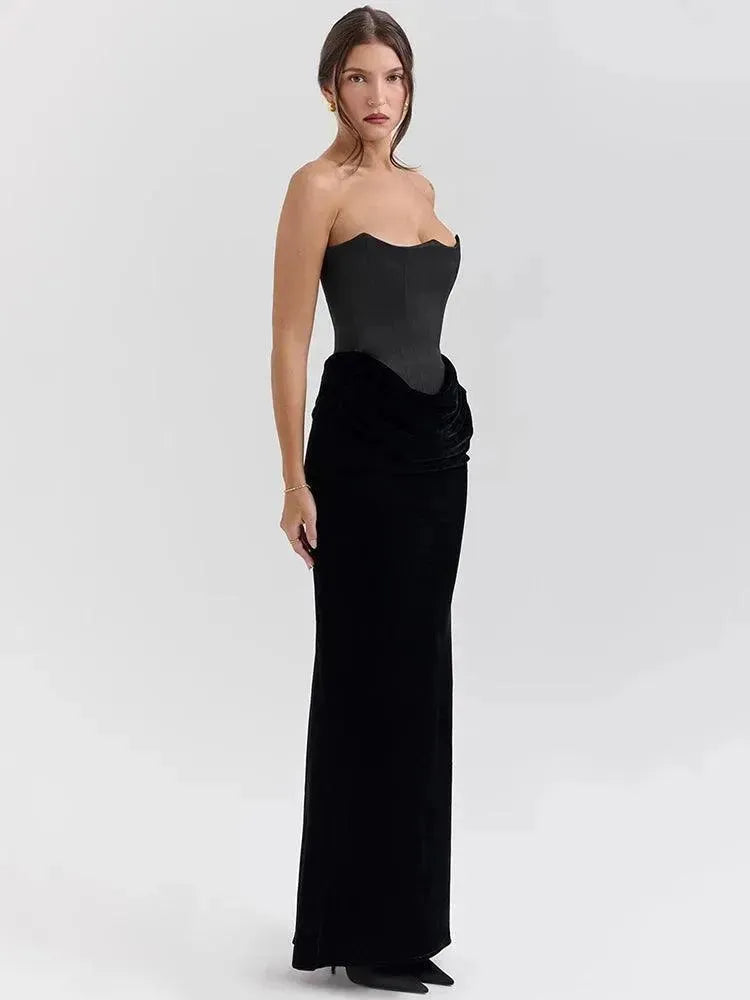 Woman wearing a black strapless gown on a white background